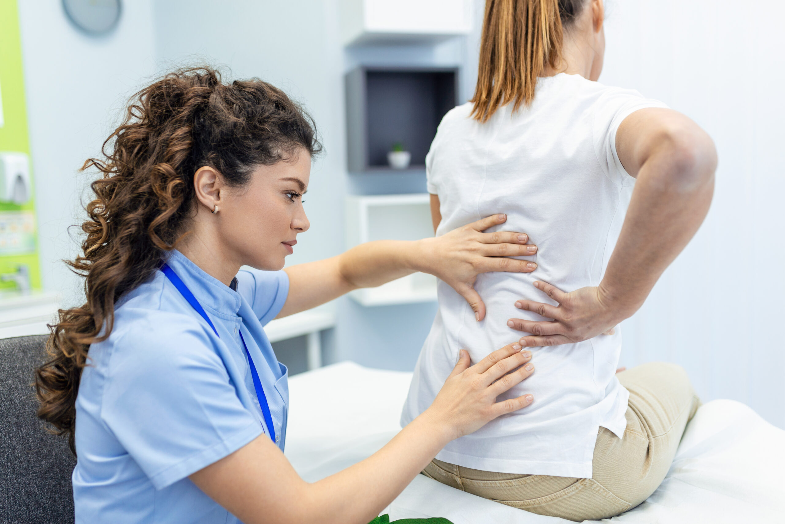 physical therapist guiding posture correction exercises for desk worker
